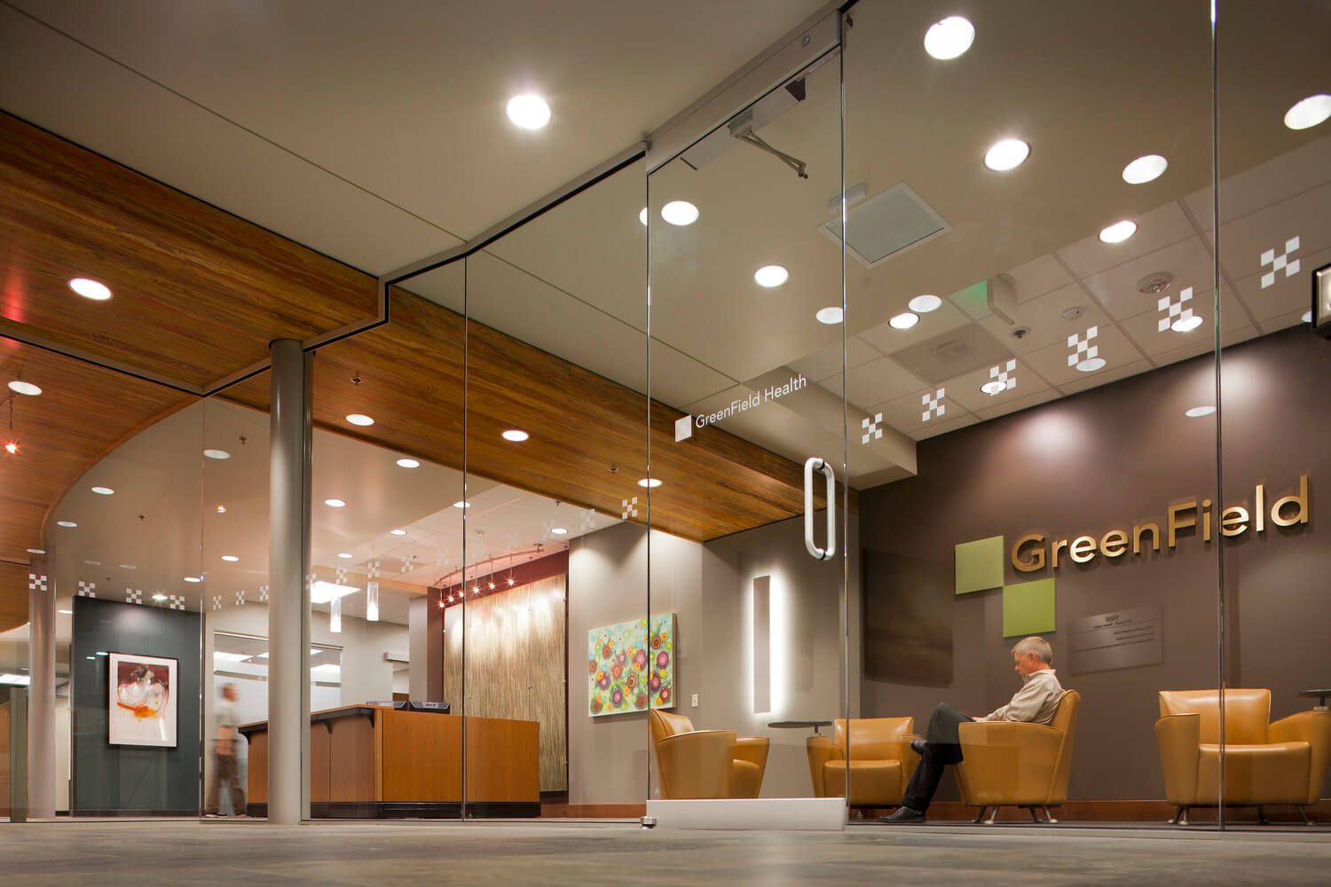 Clinic entry and reception with large glass door and windows.