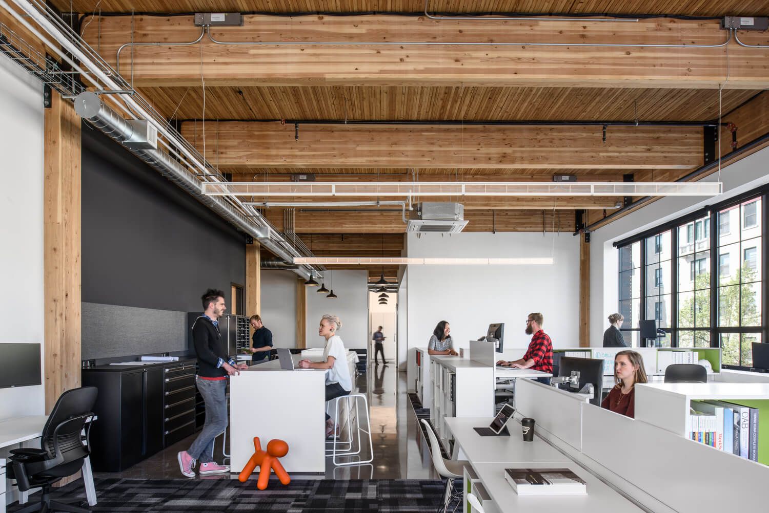An office space in the Hudson, showing exposed mass timbers supporting the ceiling