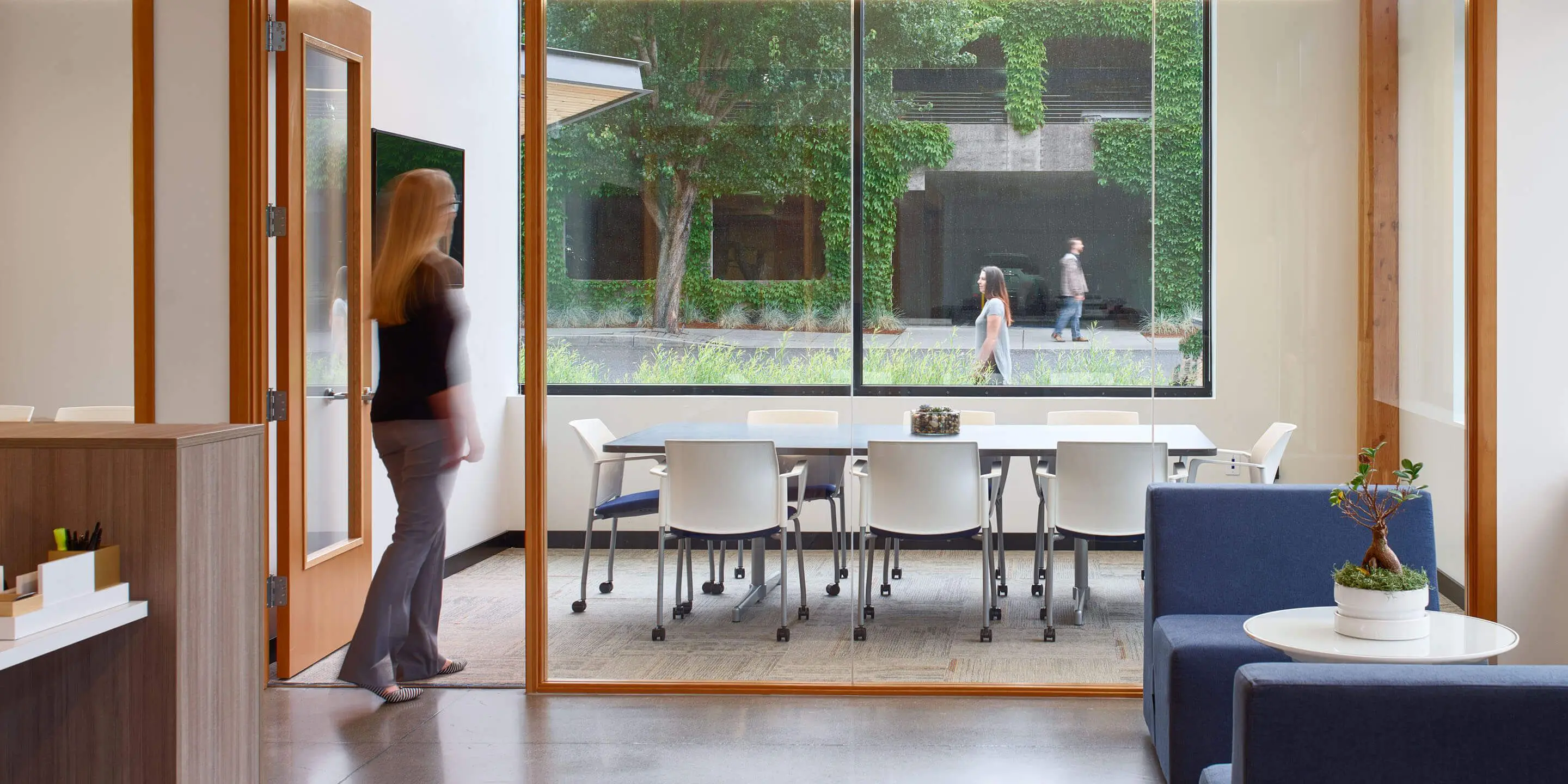 Interior office view with woman walking through door